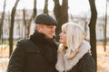 Closeup portrait of a happy blonde mature woman and a beautiful brunette middle-aged man looking at each other& x27;s eyes. Loving