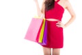 Closeup portrait of a happy excited asian woman in red dress standing and holding colorful shopping bags. Royalty Free Stock Photo