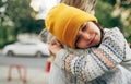 Closeup portrait of a happy little girl in the yellow hat hugging her mom. Cute kid with closed eyes embracing her mother enjoying Royalty Free Stock Photo