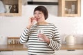 Closeup portrait of happy middle aged 50s woman holding pill taking dietary supplements. Portrait of smiling adult Royalty Free Stock Photo