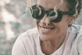 Closeup portrait of happy serene mid adult woman smiling and enjoying outdoor leisure activity and relaxation. Wearing sunglasses