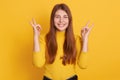 Closeup portrait of happy smiling woman showing rock sign, looking directly at camera, wearing casual attire, being in good mood, Royalty Free Stock Photo