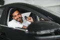 Closeup portrait happy, smiling, young man, buyer showing keys of his new car Royalty Free Stock Photo