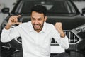 Closeup portrait happy, smiling, young man, buyer showing keys of his new car Royalty Free Stock Photo