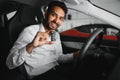 Closeup portrait happy, smiling, young man, buyer showing keys of his new car Royalty Free Stock Photo