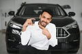 Closeup portrait happy, smiling, young man, buyer showing keys of his new car Royalty Free Stock Photo