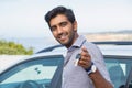 Closeup portrait happy, smiling, young man, buyer showing keys of his new car isolated outside dealership lot. Personal Royalty Free Stock Photo