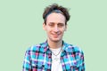 Closeup Portrait of happy successful young man in casual blue checkered shirt and headband standing and looking at camera with Royalty Free Stock Photo