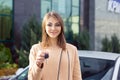 Closeup portrait happy woman, buyer near her new car showing keys Royalty Free Stock Photo