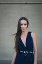 Closeup portrait of a happy young brunette teenage girl outdoor. concrete wall on background Royalty Free Stock Photo