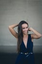 Closeup portrait of a happy young brunette teenage girl outdoor. concrete wall on background Royalty Free Stock Photo