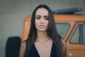 Closeup portrait of a happy young brunette teenage girl outdoor. Car going on background Royalty Free Stock Photo