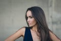 Closeup portrait of a happy young brunette teenage girl outdoor. concrete wall on background Royalty Free Stock Photo