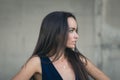 Closeup portrait of a happy young brunette teenage girl outdoor. concrete wall on background Royalty Free Stock Photo