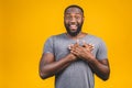 Closeup portrait of happy young handsome man looking shocked surprised open mouth eyes, isolated on yellow background. Positive