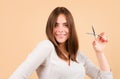 Closeup portrait of happy young woman having her hair cut with scissors at home. Beautiful girl with straight hair with Royalty Free Stock Photo