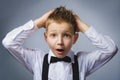 Closeup portrait headshot nervous anxious stressed afraid boy isolated grey background. Negative emotion facial