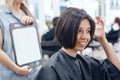 Closeup portrait of hispanic latin girl woman sitting in chair in hair salon Royalty Free Stock Photo