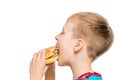 Closeup portrait of a hungry boy with a hamburger on white background