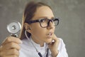 Closeup portrait of intern doctor with stethoscope listening to patient's heartbeat Royalty Free Stock Photo