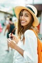 Closeup portrait joyful woman tourist in straw hat and white shirt looking to camera wiht smile. Royalty Free Stock Photo