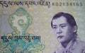 Closeup portrait of King Jigme Singye Wangchuck on old Ngultrum Bhutan currency banknote