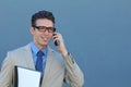 Closeup portrait of laughing young business man with glasses and wide open mouth talking on mobile phone outdoors Royalty Free Stock Photo