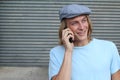 Closeup portrait of laughing young man talking on mobile phone outdoors Royalty Free Stock Photo