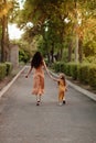 Closeup portrait of a little baby girl and mother on wheat summer field. Adventure, travel, tourism, hike and people concept - Royalty Free Stock Photo