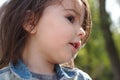 closeup portrait of little cute emotional girl with pigtails in a denim jacket