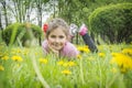 Closeup portrait of little cute girl lying with dandelions on the grass. child with flowers outdoors Royalty Free Stock Photo
