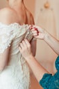 Closeup portrait of a maid of honor helping the bride