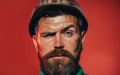 Closeup portrait of mechanical or industrial worker in protective hard hat. Serious bearded man in construction hardhat Royalty Free Stock Photo