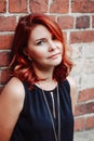 Closeup portrait of middle aged white caucasian woman with waved curly red hair with blue eyes Royalty Free Stock Photo