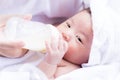 Closeup portrait of mother feeding newborn baby by milk bottle Royalty Free Stock Photo