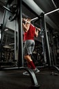 Closeup portrait of a muscular man workout with barbell at gym. Brutal bodybuilder athletic man with six pack, perfect Royalty Free Stock Photo