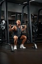 Closeup portrait of a muscular man workout with barbell at gym. Brutal bodybuilder athletic man with six pack, perfect Royalty Free Stock Photo