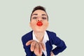 Closeup portrait of nerdy young funny distorted woman face with big red lips blowing sending  a kiss to you camera, isolated light Royalty Free Stock Photo