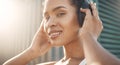 Closeup portrait of one fit young hispanic woman listening to music with headphones while exercising in an urban setting Royalty Free Stock Photo