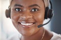 Closeup portrait of one happy african american call centre telemarketing agent with big smile talking on headset while Royalty Free Stock Photo