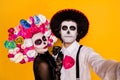 Closeup portrait photo of pretty undead creature couple man lady take selfie wear black lace dress gloves death costume Royalty Free Stock Photo