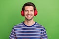 Closeup portrait photo of smiling happy youngster guy striped t shirt listen comfort brand new headphones isolated on