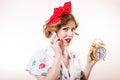 Closeup portrait of pinup woman with alarm clock on the phone