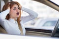 Closeup portrait of pissed off displeased angry aggressive woman driving a car shouting at someone. Negative human expression