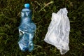 Closeup portrait of plastic bag and plastic used bottle, rubbish in meadow, trash in field, ecological problems, waste,