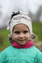 Closeup portrait of a playful four year old caucasian girl squinting her eyes