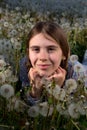 Closeup Portrait of Pretty Girl Resting on Dandelion Field on Sunny Spring Day Royalty Free Stock Photo