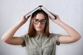 A closeup portrait of pretty young schoolgirl wearing glasses on white background. Royalty Free Stock Photo