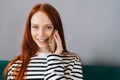 Closeup portrait of pretty young woman talking on smartphone smiling looking at camera. Cheerful female making answering Royalty Free Stock Photo