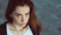 Closeup portrait. Red-haired girl with a serious facial expression looking at the camera Royalty Free Stock Photo